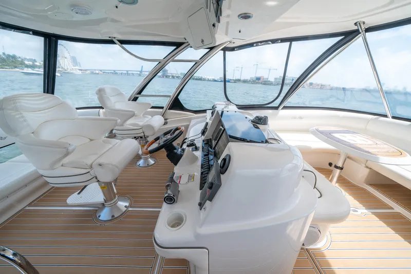 Slide: The Image of 2006 Sea Ray 58 Sedan Bridge helm with panoramic views and luxurious seating. - 42