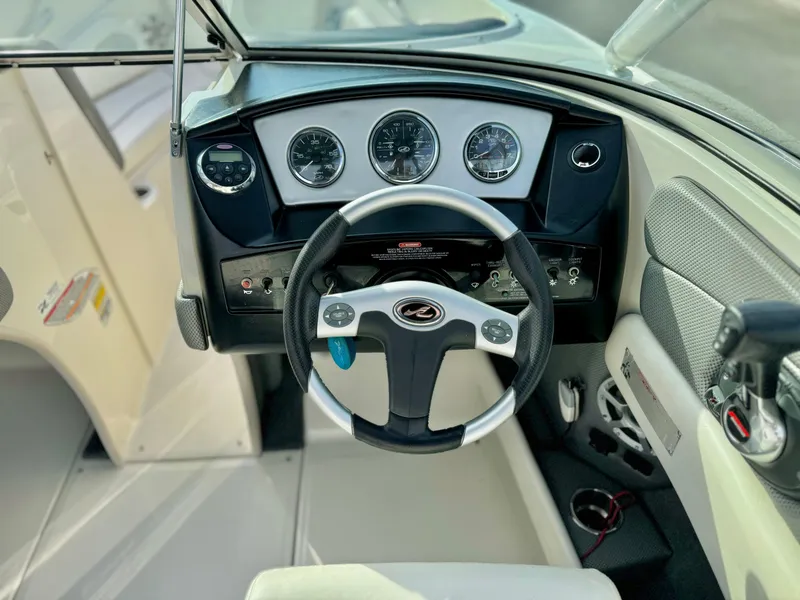 Slide: The Image of 2008 Sea Ray 230 Select Fission boat dashboard with steering wheel and gauges. - 14