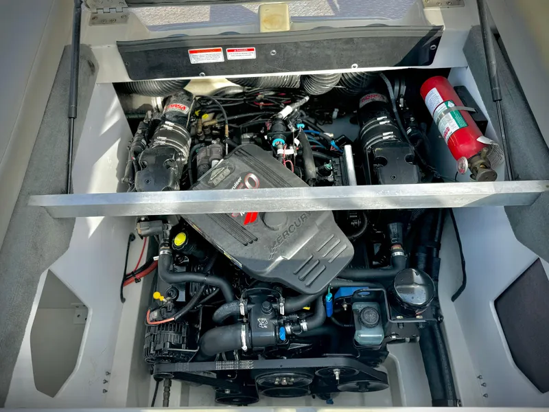 Slide: The Image of 2008 Sea Ray 230 Select Fission engine compartment with visible components and fire extinguisher. - 21