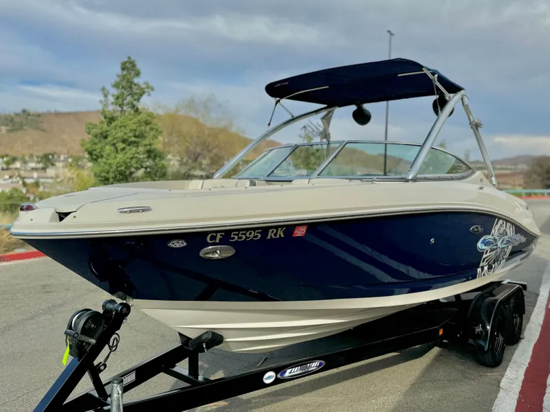 Slide: The Image of 2008 Sea Ray 230 Select Fission boat on trailer, parked outdoors. - 3