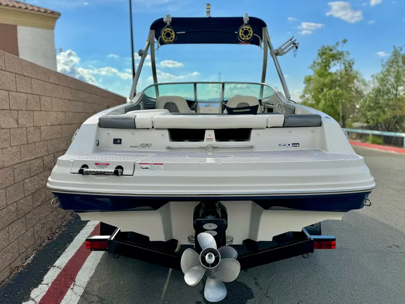 Slide: The Image of 2008 Sea Ray 230 Select Fission boat, rear view, parked on a street. - 4