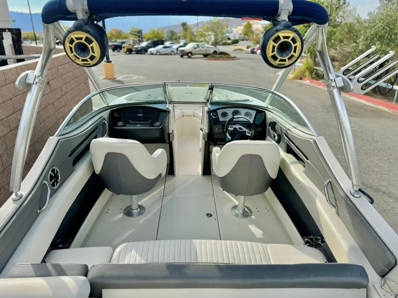 Slide: The Image of 2008 Sea Ray 230 Select Fission boat interior with dual seats and dashboard view. - 8