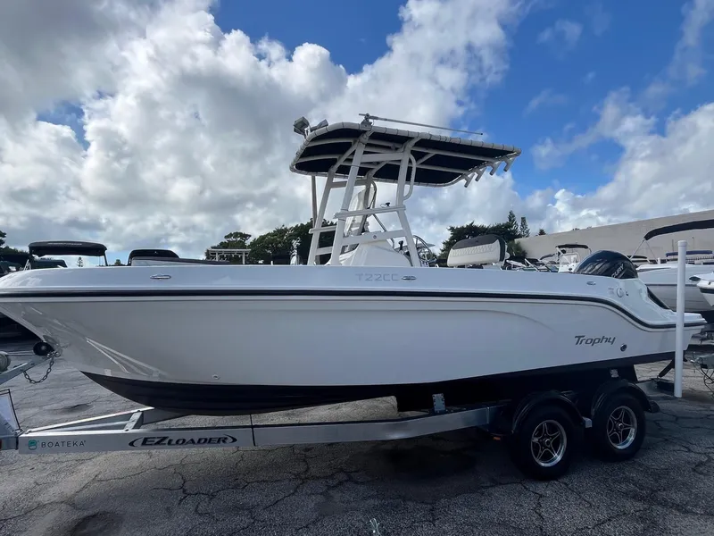 Slide: The Image of 2022 Bayliner Trophy T22CC boat on trailer under cloudy sky. - 1