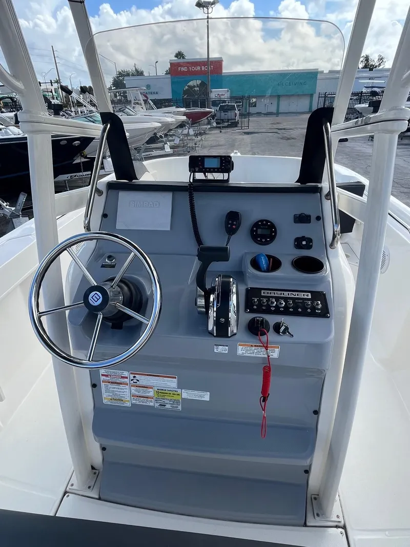 Slide: The Image of 2022 Bayliner Trophy T22CC boat console with steering wheel and controls. - 5