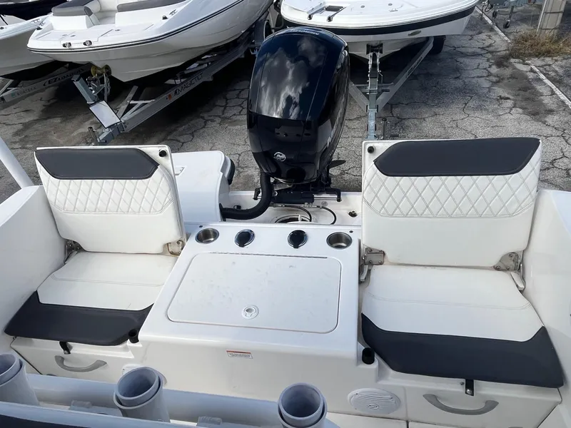 Slide: The Image of 2022 Bayliner Trophy T22CC boat with dual seating and outboard motor. - 6