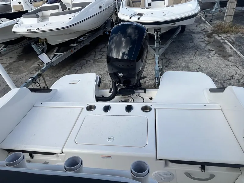 Slide: The Image of 2022 Bayliner Trophy T22CC boat with outboard motor, docked on a trailer. - 7