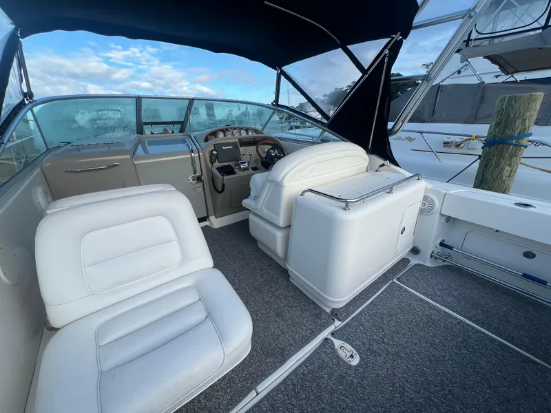 Slide: The Image of 2007 Sea Ray 290 Amberjack boat interior with white seating and steering console. - 10