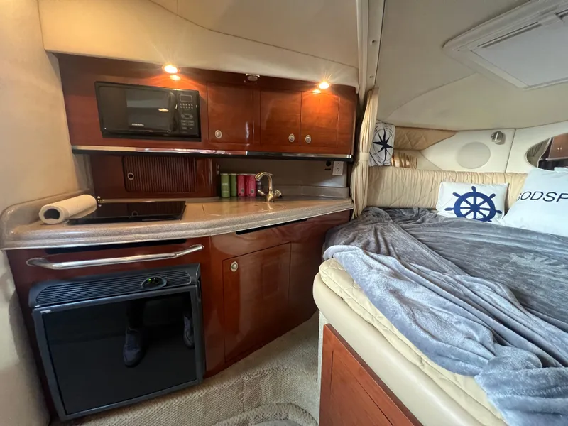 Slide: The Image of Interior of 2007 Sea Ray 290 Amberjack with kitchenette and cozy sleeping area. - 17