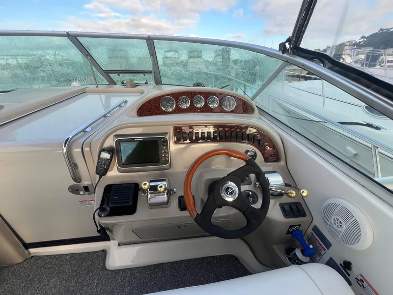 Slide: The Image of 2007 Sea Ray 290 Amberjack helm with steering wheel, gauges, and navigation equipment. - 21