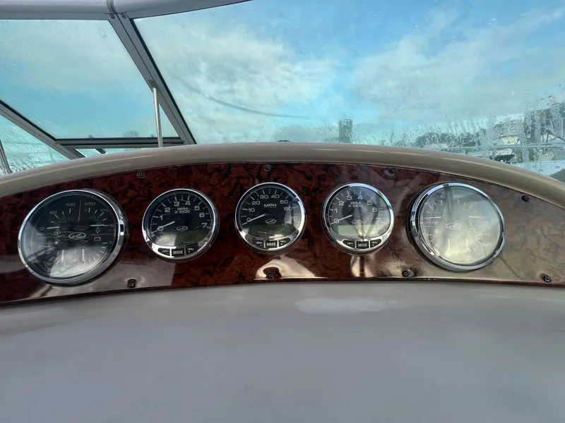 Slide: The Image of Dashboard of 2007 Sea Ray 290 Amberjack boat with gauges and clear sky view. - 24