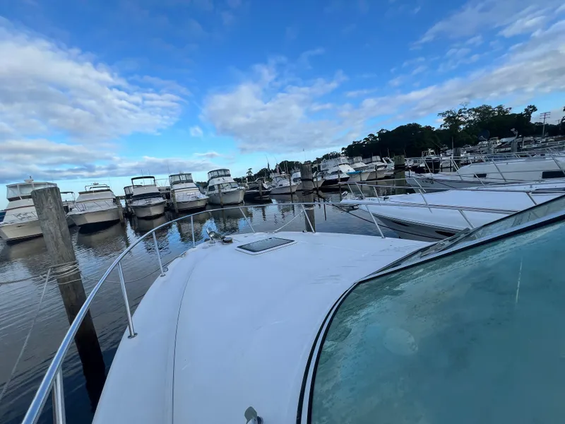 Slide: The Image of 2007 Sea Ray 290 Amberjack docked among other boats under a partly cloudy sky. - 27