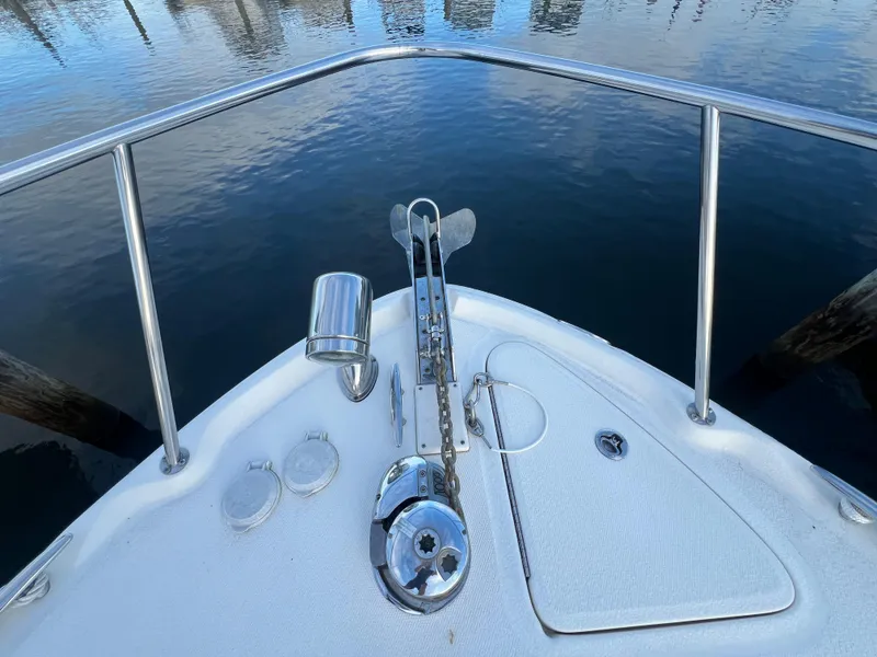 Slide: The Image of Bow of 2007 Sea Ray 290 Amberjack with anchor and railing, reflecting on water. - 28