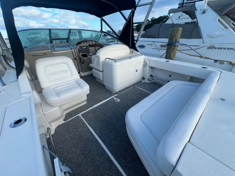 Slide: The Image of 2007 Sea Ray 290 Amberjack boat interior with white seating and steering console. - 6
