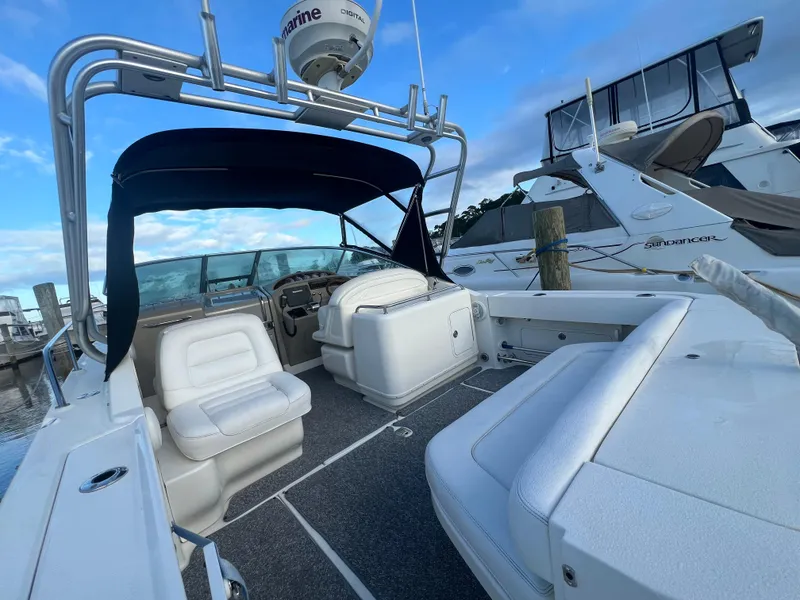 Slide: The Image of 2007 Sea Ray 290 Amberjack boat interior with seating and helm, docked at marina. - 7