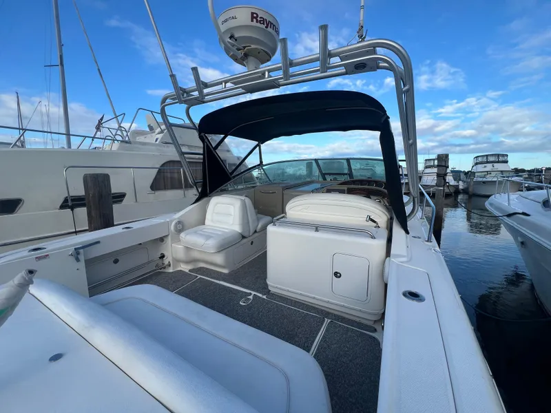 Slide: The Image of 2007 Sea Ray 290 Amberjack boat docked at marina, featuring spacious seating and canopy. - 9