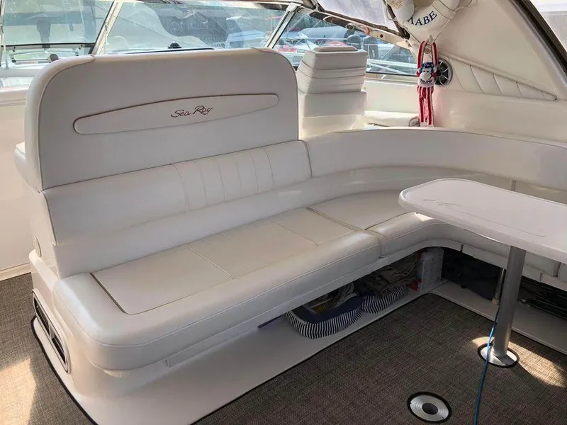 Slide: The Image of Luxurious interior of 1997 Sea Ray 400 Sundancer yacht with white seating and table. - 14