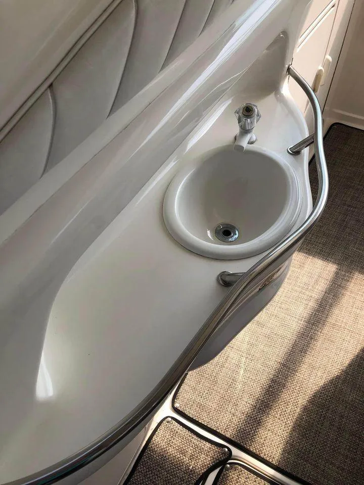 Slide: The Image of 1997 Sea Ray 400 Sundancer yacht bathroom sink with chrome fixtures and curved design. - 15