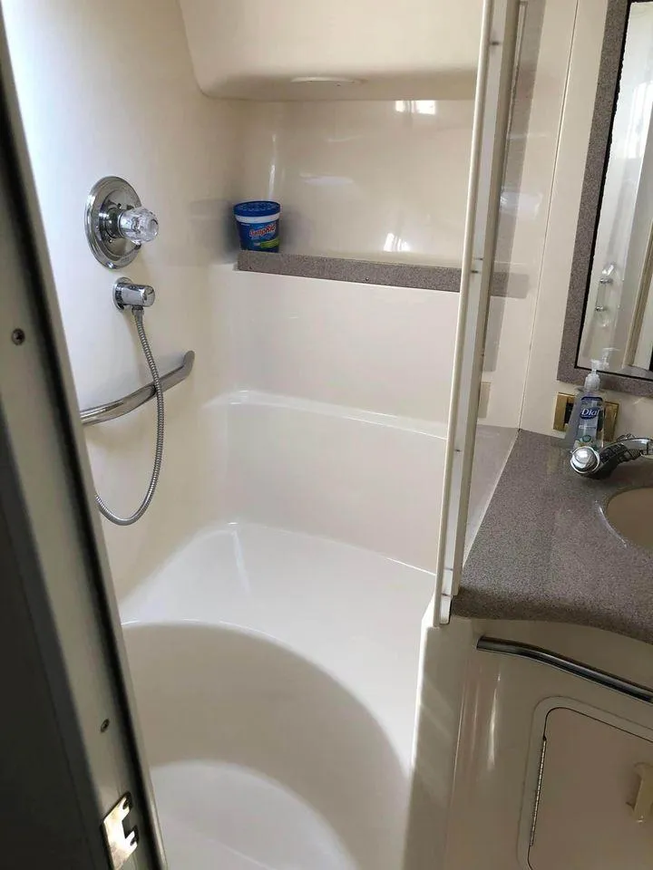 Slide: The Image of Bathroom interior of 1997 Sea Ray 400 Sundancer yacht, featuring shower and sink. - 4