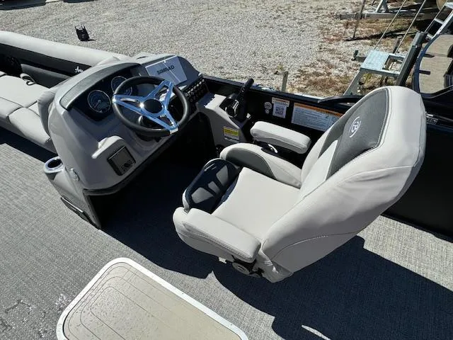 Slide: The Image of 2025 Barletta Aria 24UC boat interior with steering wheel and captain's chair. - 17