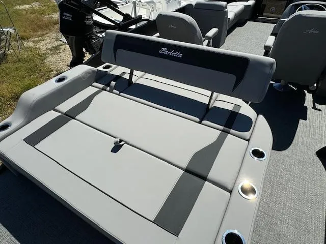 Slide: The Image of 2025 Barletta Aria 24UC boat interior with gray seating and cup holders. - 21