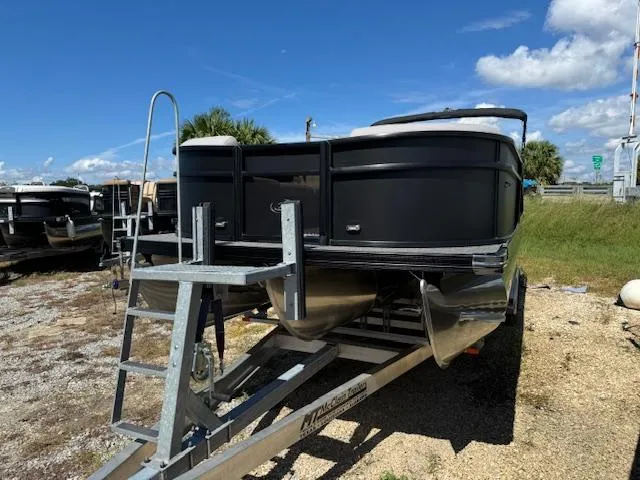 Slide: The Image of 2025 Barletta Aria 24UC pontoon boat on trailer under clear blue sky. - 4