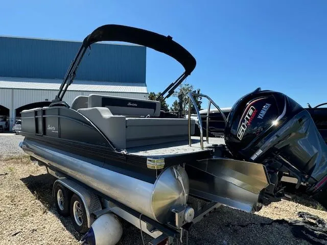 Slide: The Image of 2025 Barletta Aria 24UC pontoon boat with Yamaha engine, parked on a trailer. - 6