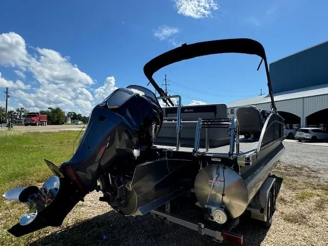 Slide: The Image of 2025 Barletta Aria 24UC pontoon boat with powerful outboard motor, parked outdoors. - 8