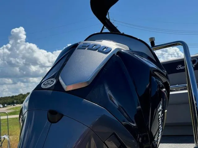 Slide: The Image of 2025 Barletta Aria 24UC boat engine close-up under blue sky. - 9