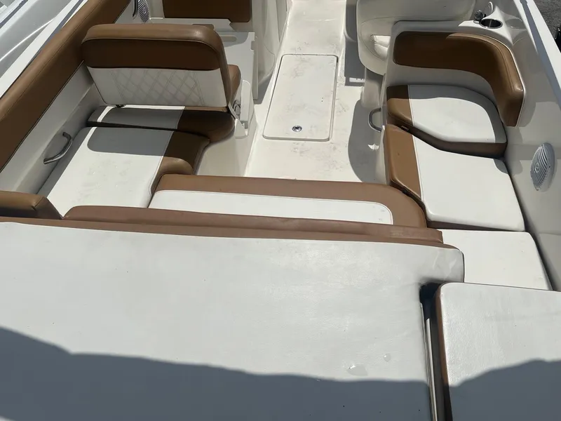 Slide: The Image of 2021 Bayliner VR6 boat interior with white and brown seating arrangement. - 3
