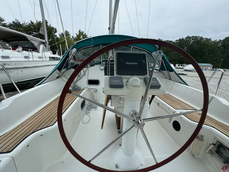 Slide: The Image of 2008 Beneteau Oceanis 37 sailboat cockpit with steering wheel and navigation equipment. - 13