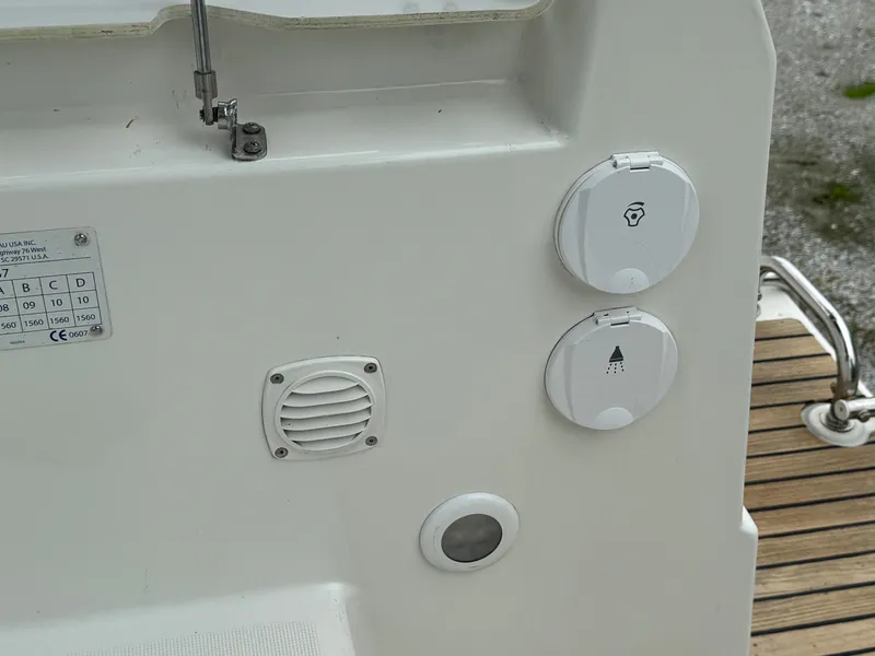 Slide: The Image of Beneteau Oceanis 37 (2008) yacht deck controls and outlets, featuring light and power symbols. - 14
