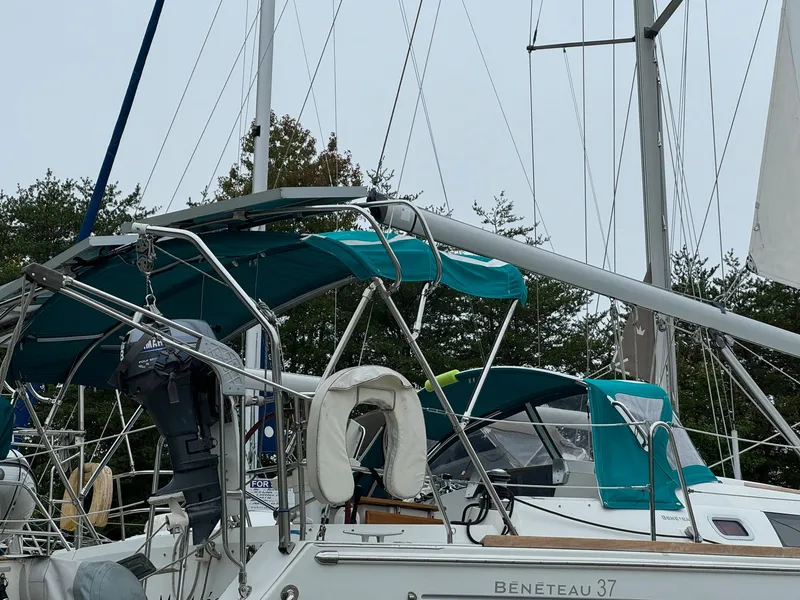 Slide: The Image of 2008 Beneteau Oceanis 37 sailboat with teal canopy and rigging. - 19