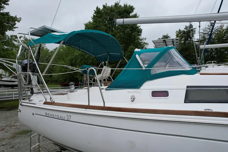 Slide: The Image of 2008 Beneteau Oceanis 37 sailboat with teal canopy, docked outdoors. - 23