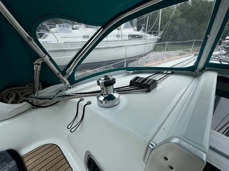 Slide: The Image of 2008 Beneteau Oceanis 37 cockpit with winch and ropes, docked near another sailboat. - 27