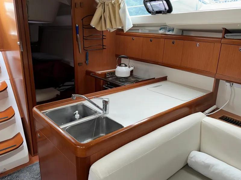 Slide: The Image of Interior of 2008 Beneteau Oceanis 37 sailboat with modern kitchen and seating area. - 35