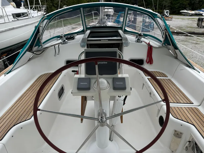 Slide: The Image of Cockpit of 2008 Beneteau Oceanis 37 sailboat with wooden accents and steering wheel. - 4