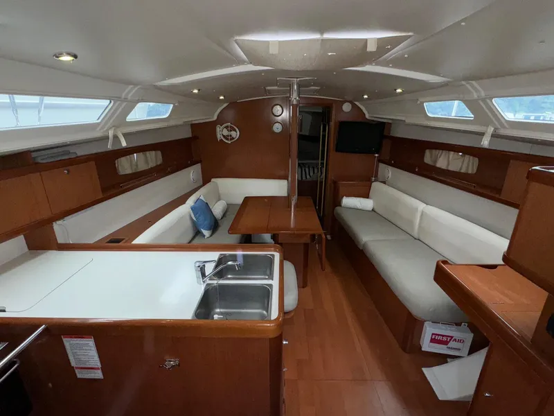 Slide: The Image of Interior of 2008 Beneteau Oceanis 37 sailboat with modern wood finish and cozy seating. - 43