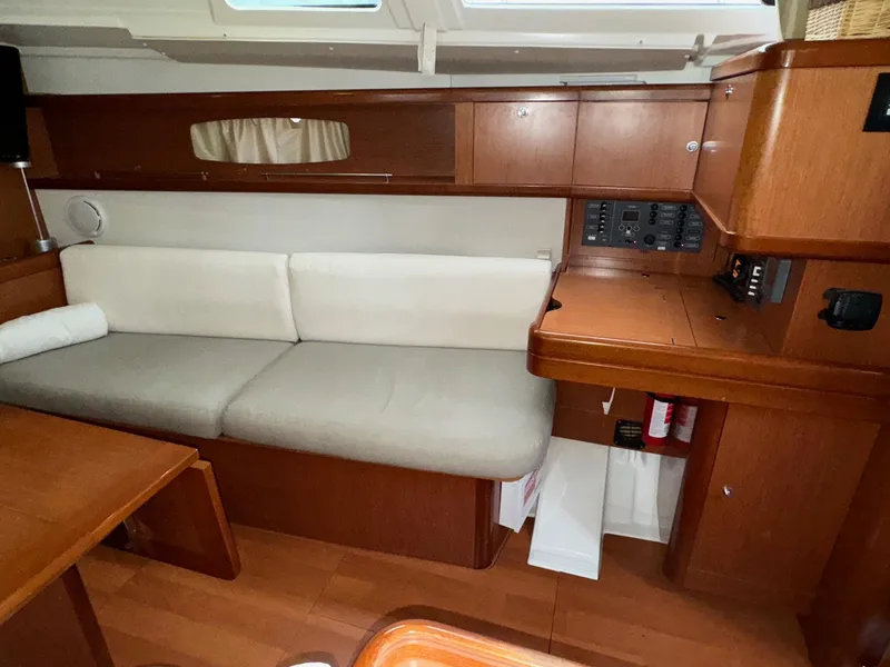 Slide: The Image of Interior of 2008 Beneteau Oceanis 37 sailboat with wooden cabinetry and beige seating. - 45