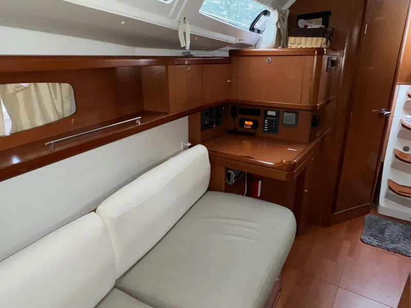 Slide: The Image of Interior of 2008 Beneteau Oceanis 37 sailboat with wood finish and seating area. - 46