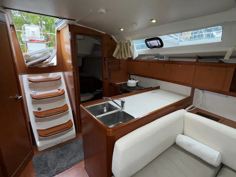 Slide: The Image of Interior of 2008 Beneteau Oceanis 37 sailboat, featuring kitchen and seating area. - 47