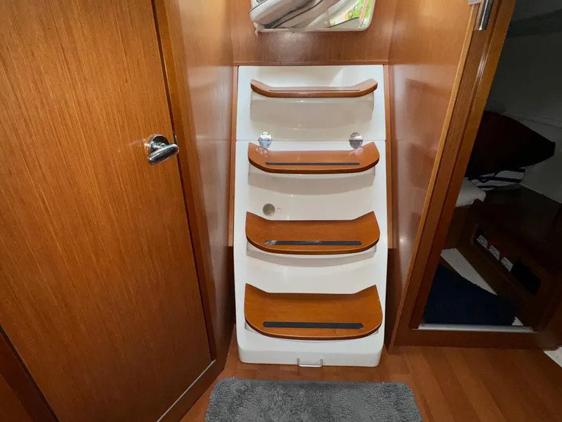 Slide: The Image of Interior stairs of 2008 Beneteau Oceanis 37 sailboat, featuring wooden steps and modern design. - 48