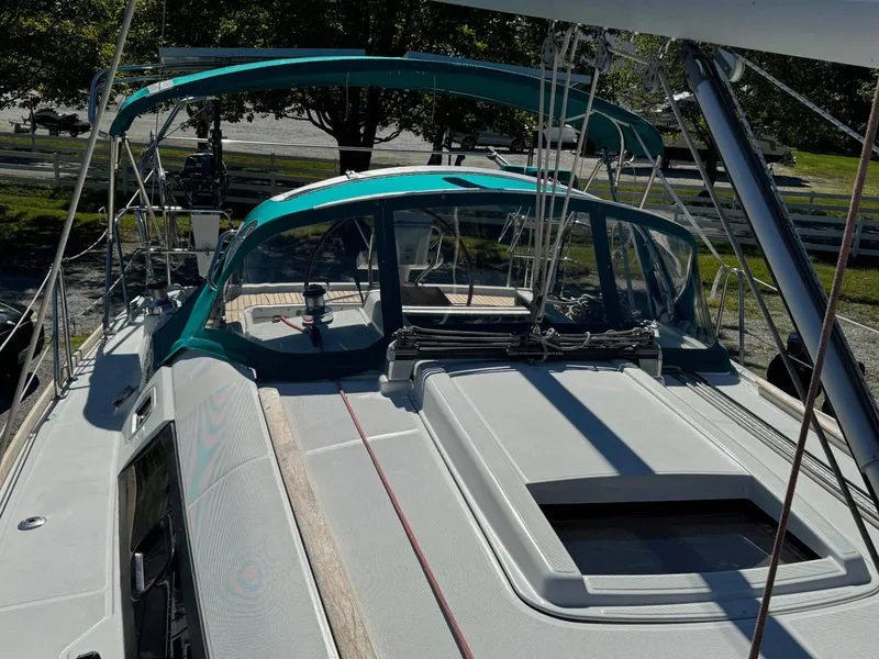 Slide: The Image of 2008 Beneteau Oceanis 37 sailboat with teal canopy, docked outdoors. - 8