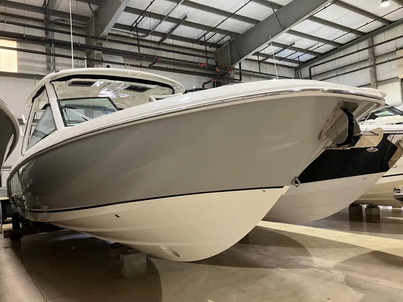Slide: The Image of 2024 Boston Whaler 320 Vantage boat in a showroom, showcasing sleek design and craftsmanship. - 0