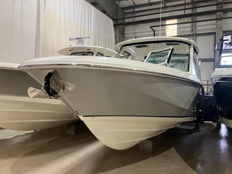 Slide: The Image of 2024 Boston Whaler 320 Vantage boat in a showroom, showcasing sleek design and modern features. - 1
