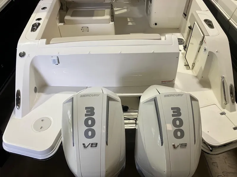 Slide: The Image of 2024 Boston Whaler 320 Vantage with twin Mercury 300 V8 engines, rear view. - 2