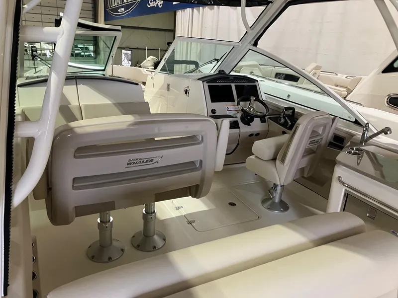 Slide: The Image of 2024 Boston Whaler 320 Vantage boat interior with helm and seating area. - 5
