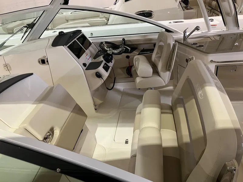 Slide: The Image of 2024 Boston Whaler 320 Vantage boat interior with modern seating and control panel. - 6