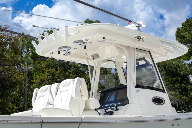 Slide: The Image of 2023 Regulator 34 boat with sleek design and modern features, set against a cloudy sky. - 11