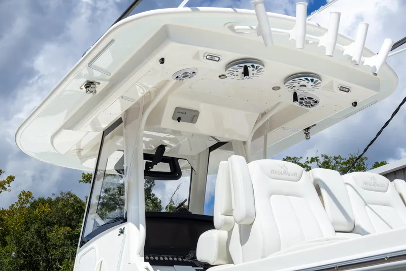 Slide: The Image of 2023 Regulator 34 boat with white seating and modern helm design. - 13