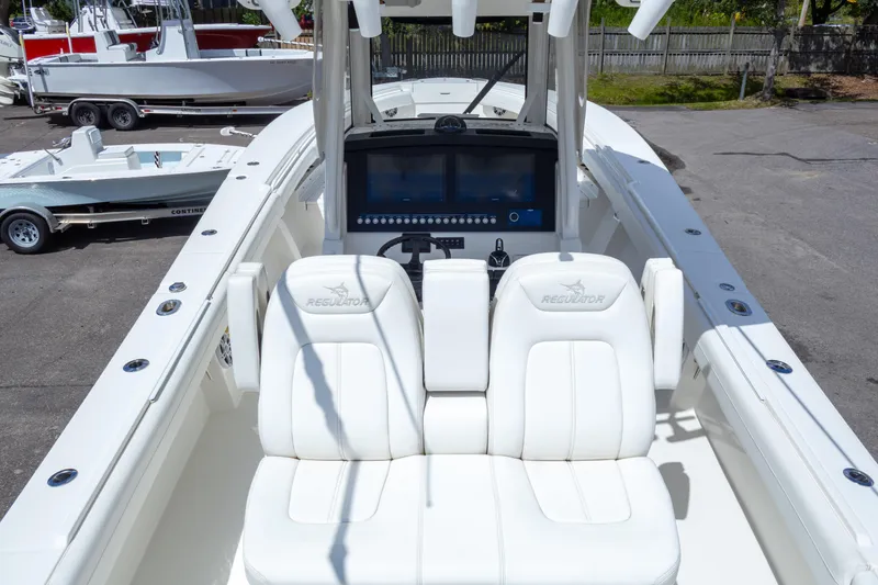 Slide: The Image of 2023 Regulator 34 boat with white seating and advanced dashboard display. - 15